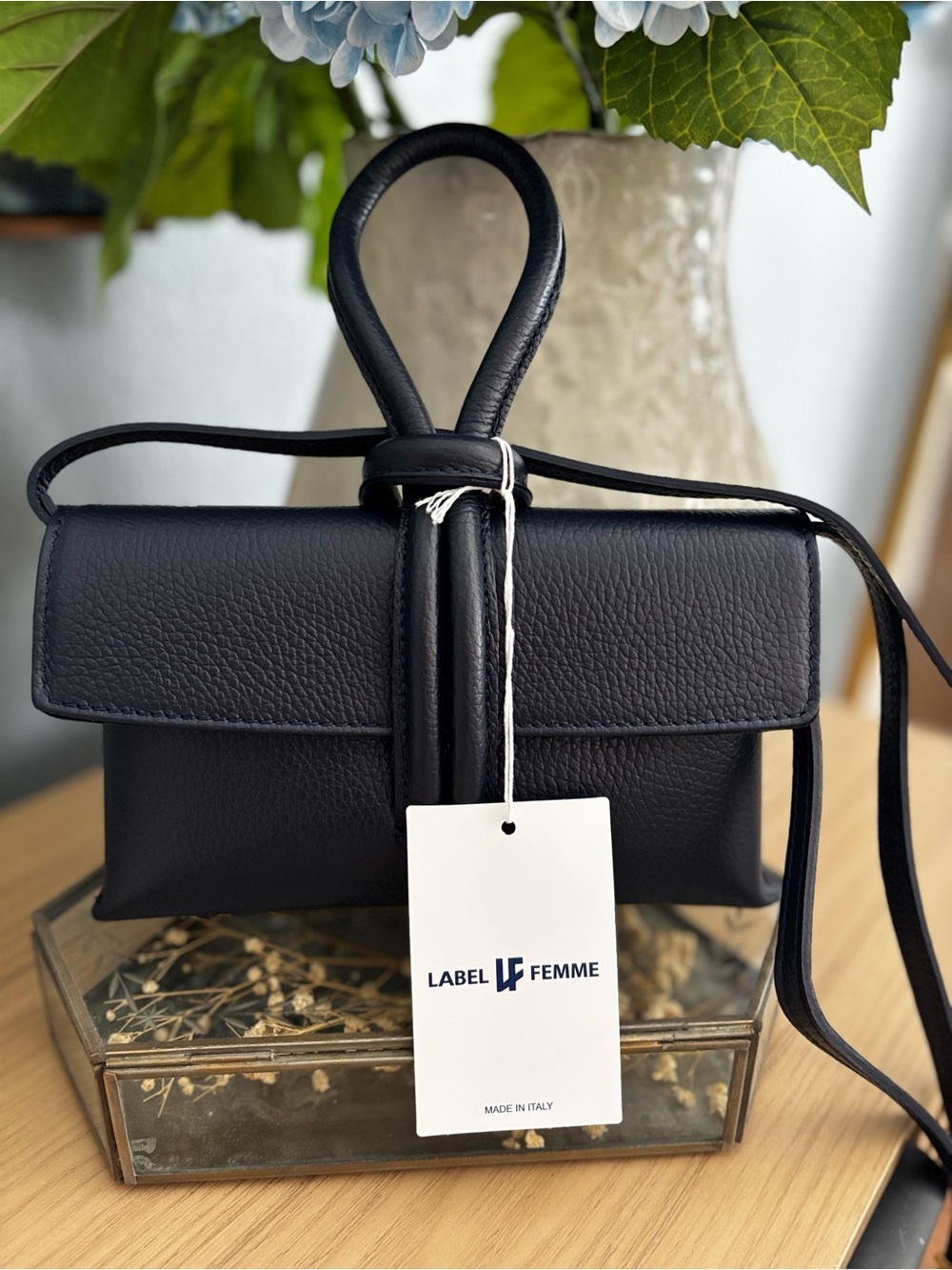 Label Femme leather navy clutch with Loop-Knot and detachable shoulder strap.